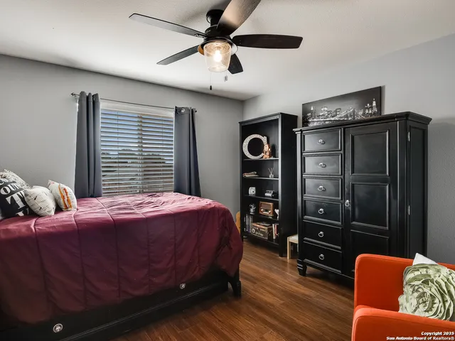 a bedroom with a bed dresser and a window