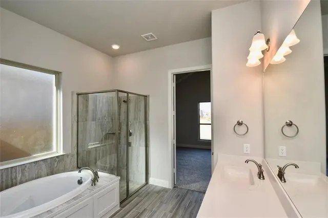 a bathroom with a tub a sink and mirrors