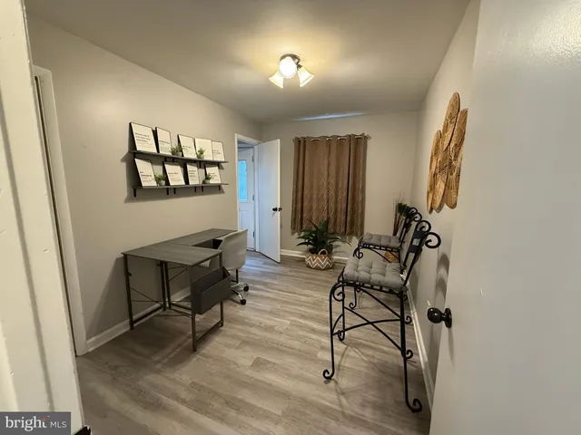 a view of a livingroom with furniture and a window