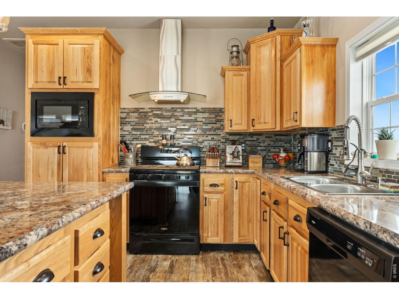 62 Rabbit Ears Court Livermore, CO 80536 - Photo 12 of 36 a kitchen with stainless steel appliances granite countertop a stove a sink and a microwave