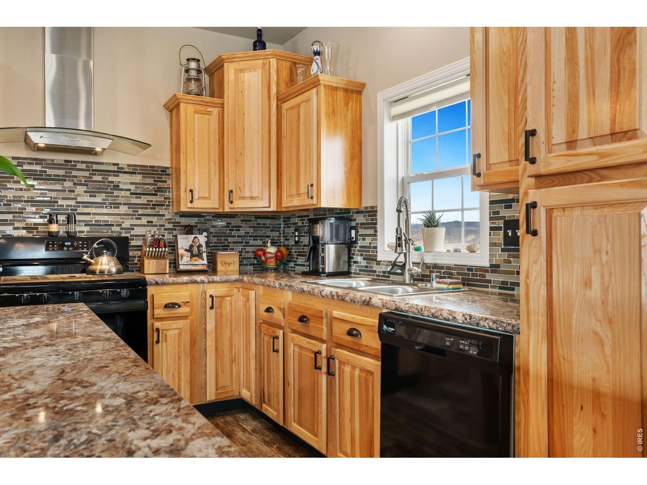 62 Rabbit Ears Court Livermore, CO 80536 - Photo 14 of 36 a kitchen with stainless steel appliances granite countertop a sink a stove and cabinets