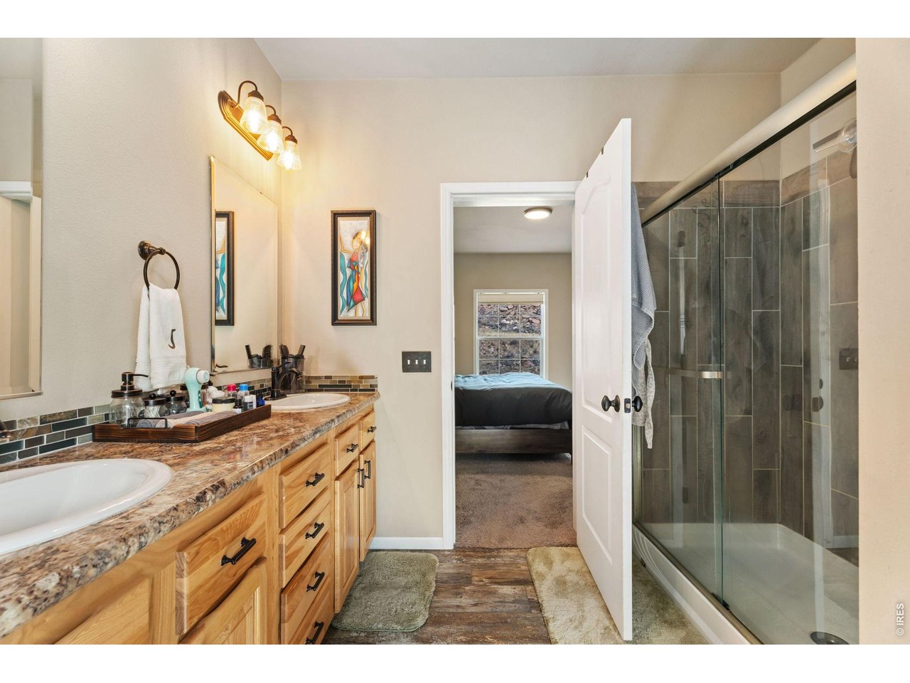 62 Rabbit Ears Court Livermore, CO 80536 - Photo 26 of 36 a bathroom with a granite countertop sink mirror and double