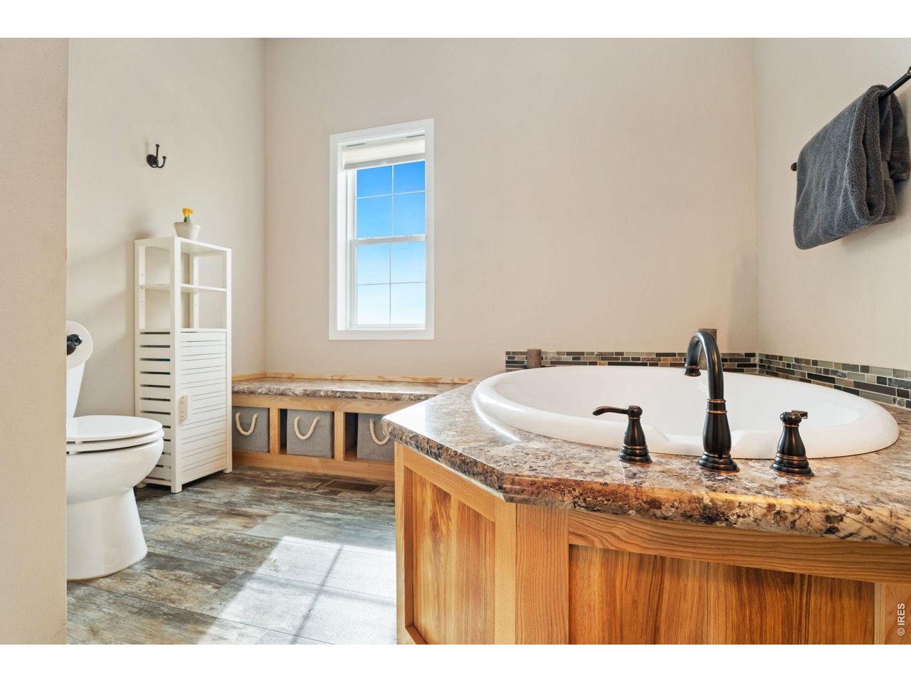 62 Rabbit Ears Court Livermore, CO 80536 - Photo 27 of 36 a bathroom with a granite countertop sink a toilet a mirror and shower