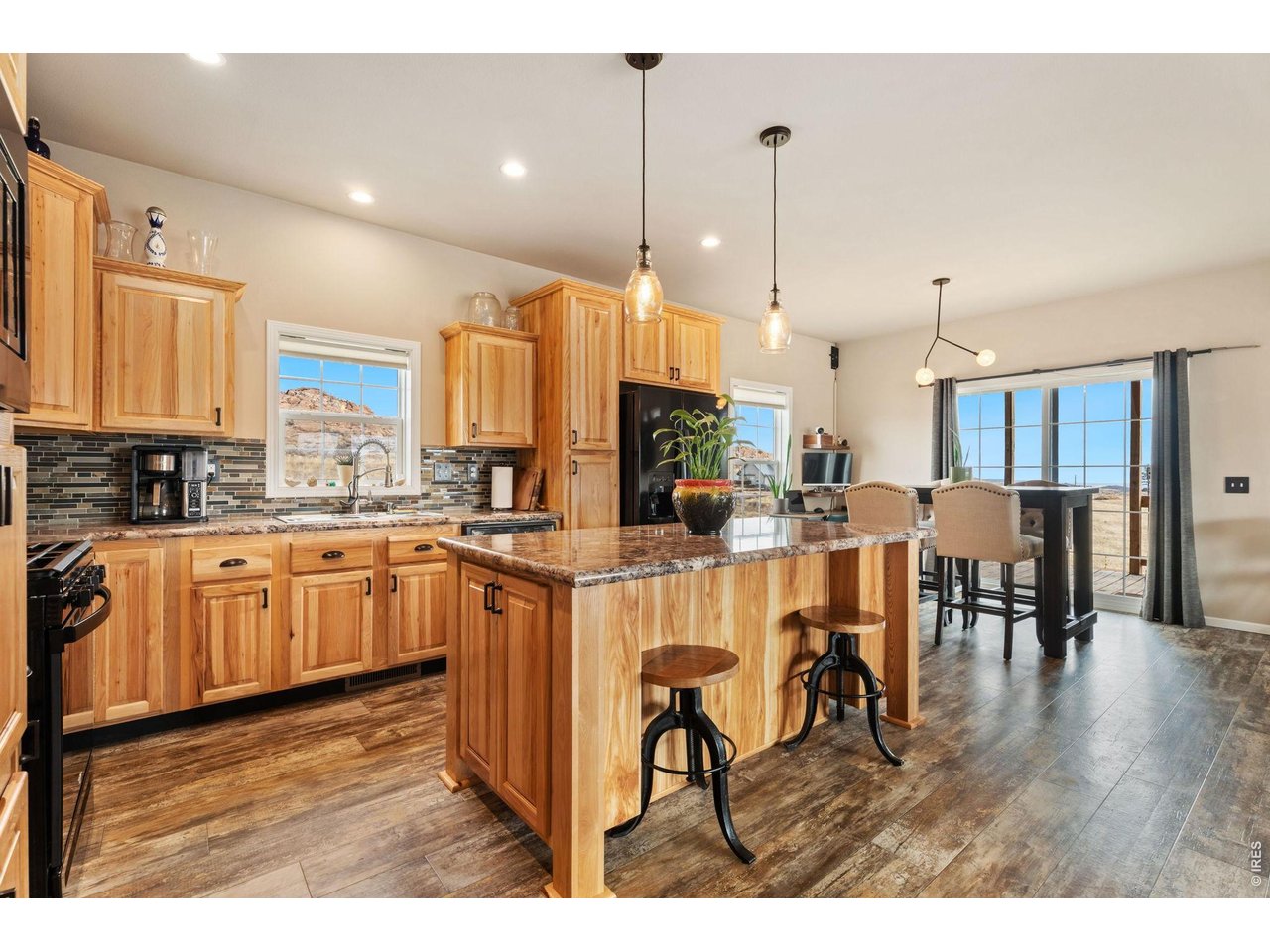 62 Rabbit Ears Court Livermore, CO 80536 - Photo 9 of 36 a kitchen with stainless steel appliances granite countertop a stove top oven a sink a dining table and chairs