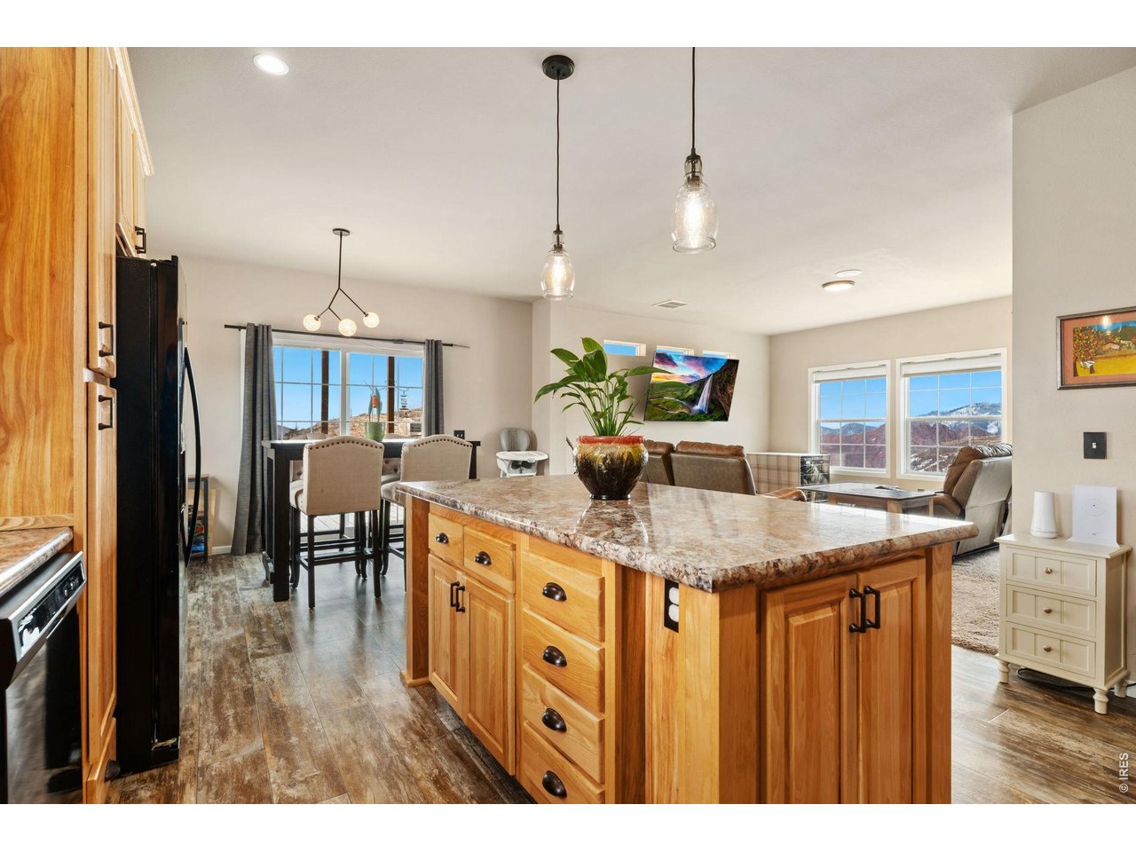 62 Rabbit Ears Court Livermore, CO 80536 - Photo 10 of 36 a kitchen with stainless steel appliances kitchen island granite countertop a table chairs and a refrigerator