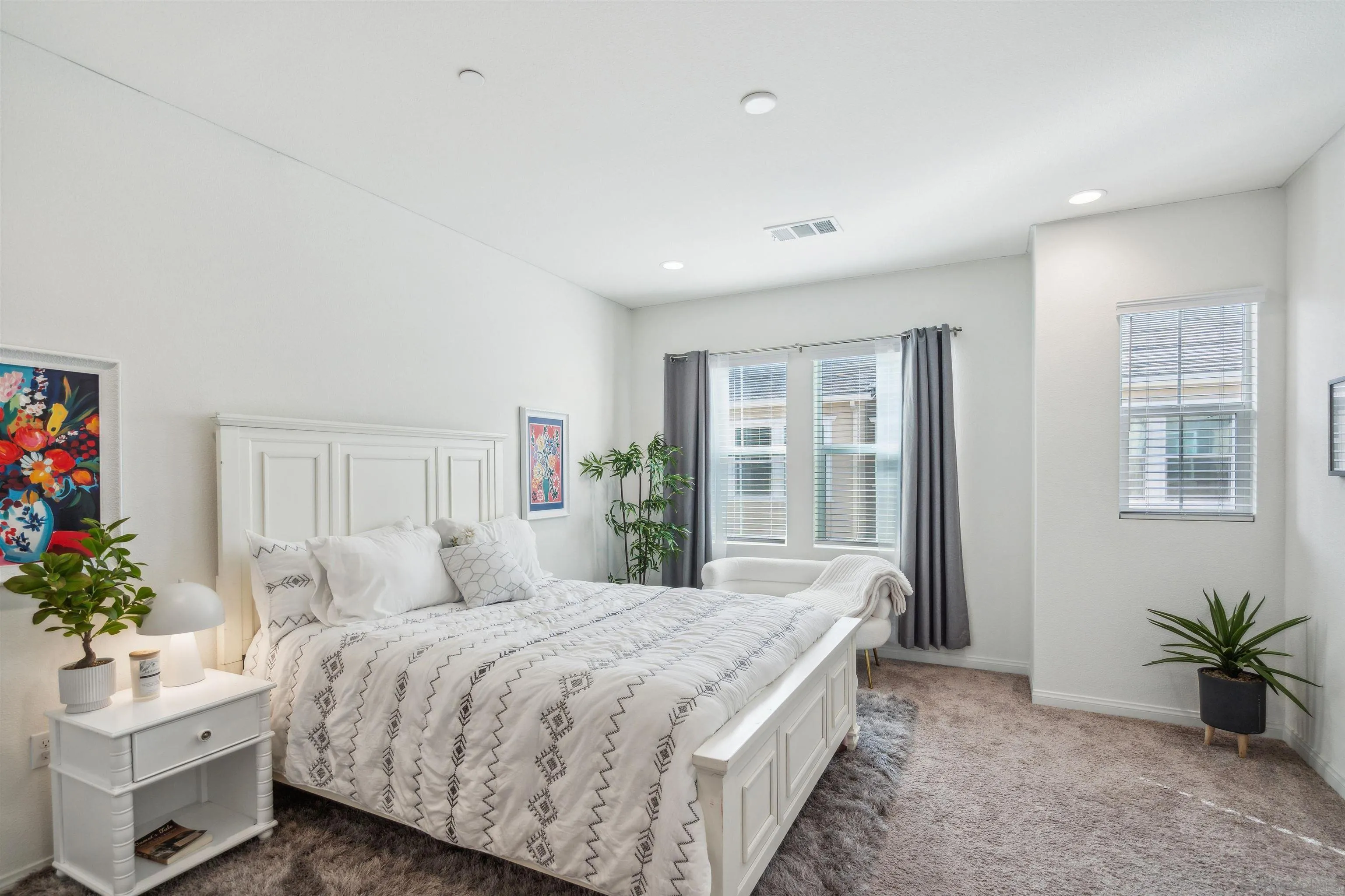 2018 Barite Street Spring Valley, CA 91977 - Photo 25 of 47 a bedroom with a large bed and a potted plant