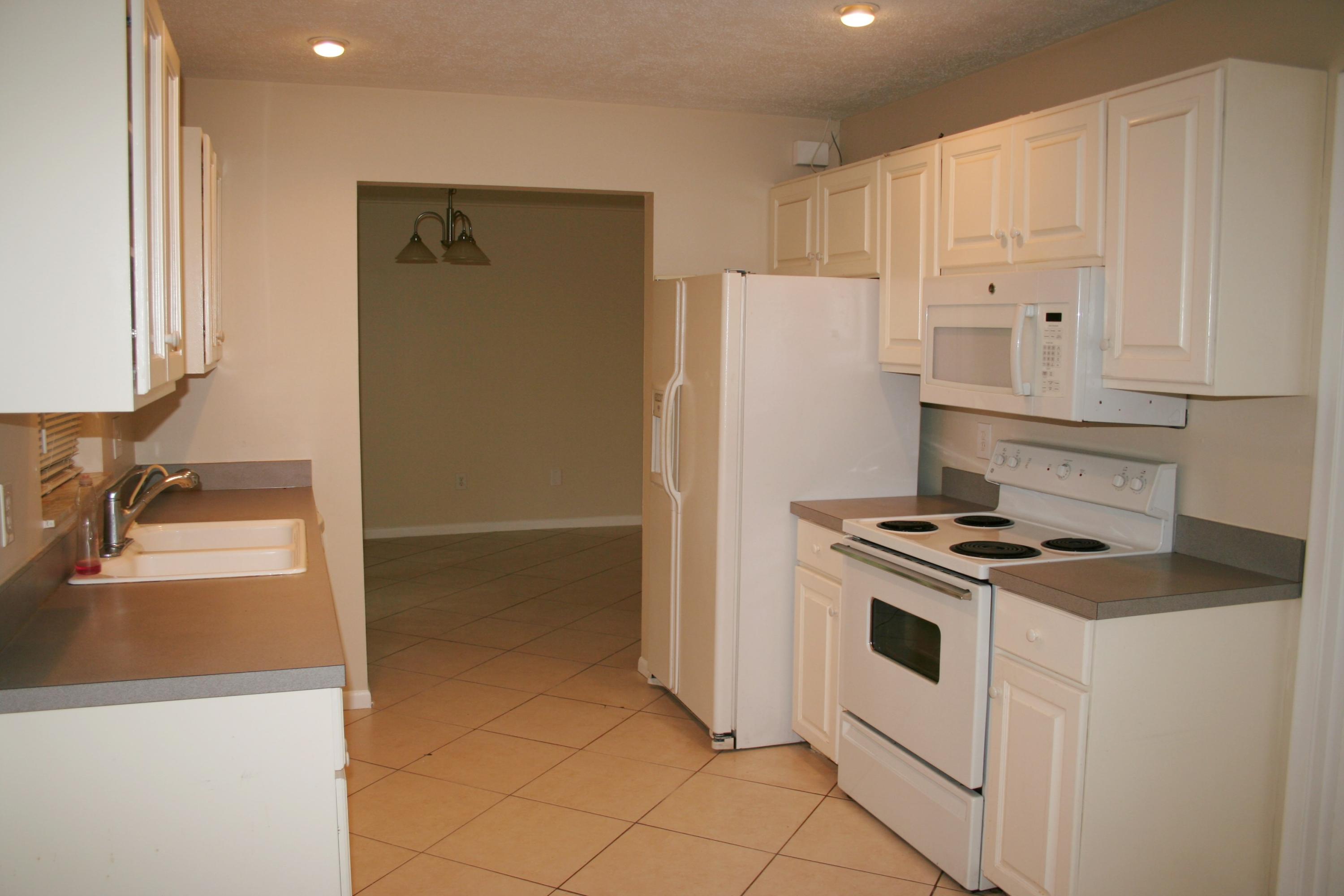 22676 Southwest 65th Terrace Boca Raton, FL 33428 - Photo 4 of 12 a kitchen with a stove and a refrigerator