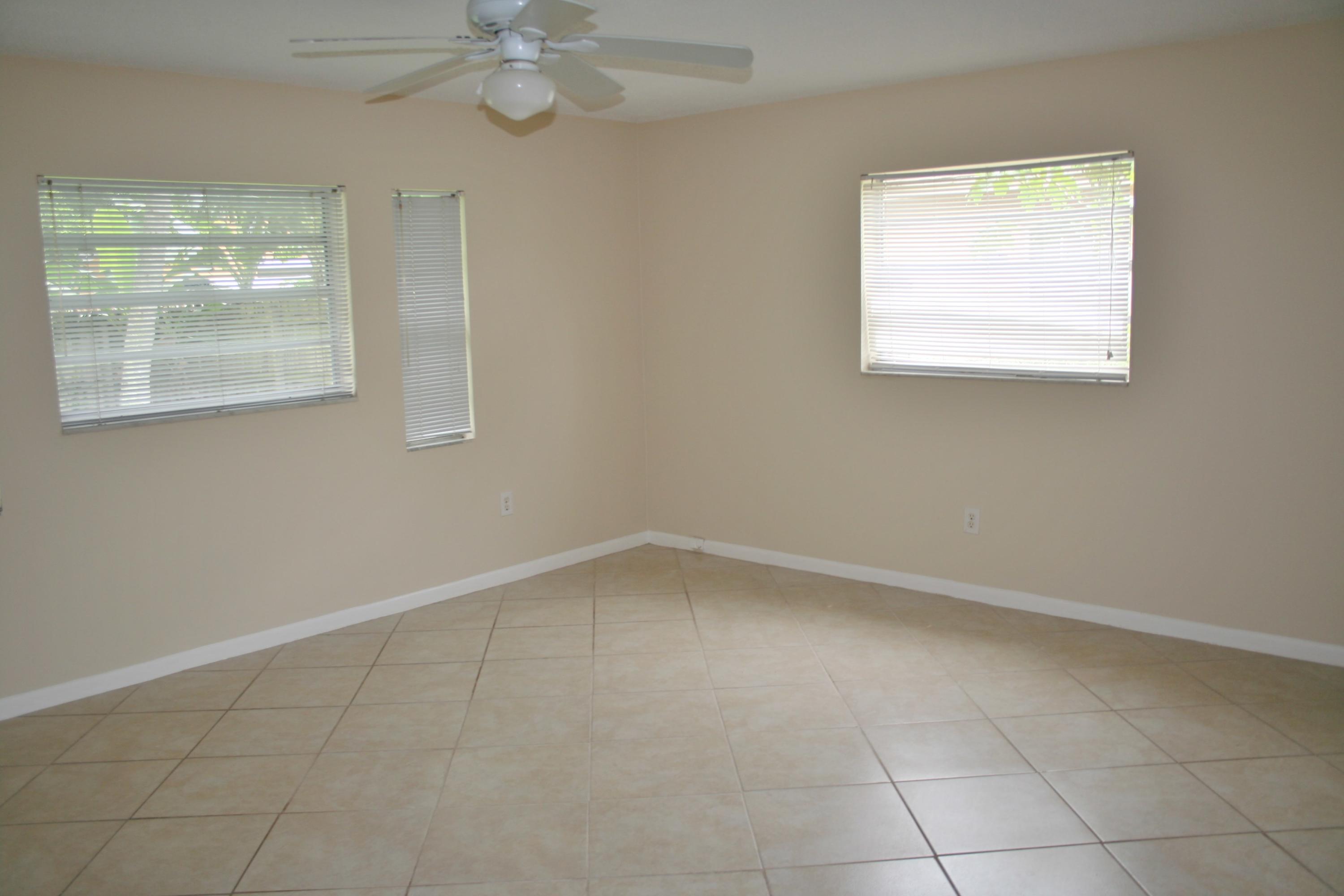 22676 Southwest 65th Terrace Boca Raton, FL 33428 - Photo 5 of 12 an empty room with windows and fan