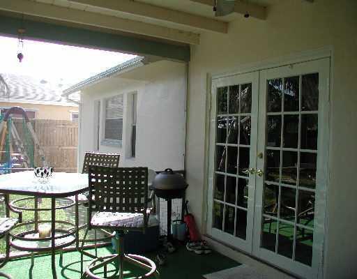 22676 Southwest 65th Terrace Boca Raton, FL 33428 - Photo 8 of 12 a view of a porch with furniture and a yard