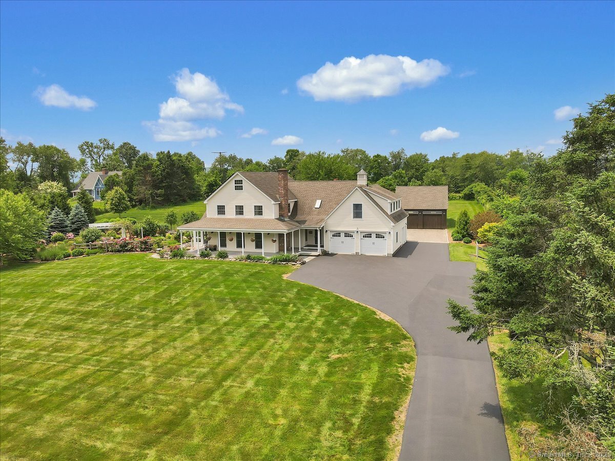 a view of a house with a yard and potted plants