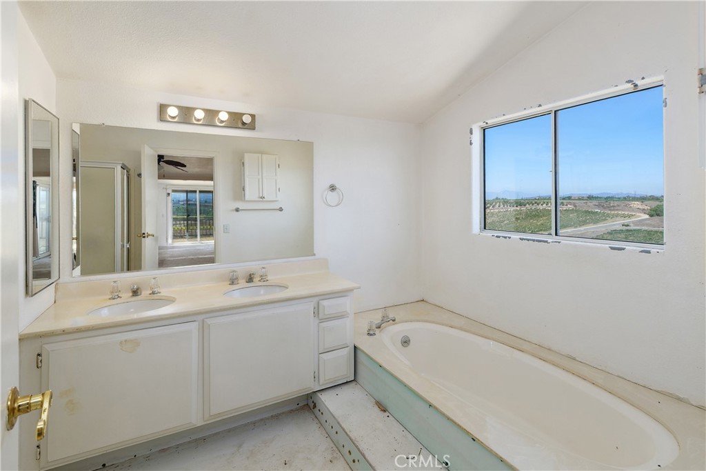 34881 Los Nogales Road Temecula, CA 92592 - Photo 33 of 50 Primary bath with double sinks, soaking tub, walk-in shower not shown, no toilet.