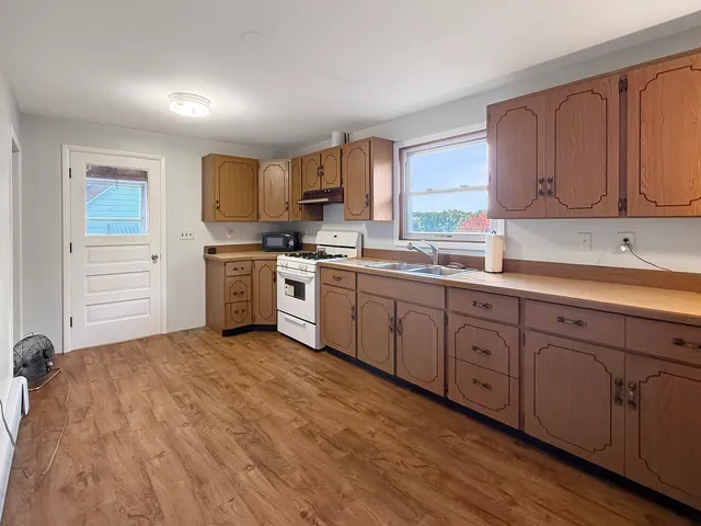 a kitchen with a sink cabinets and window