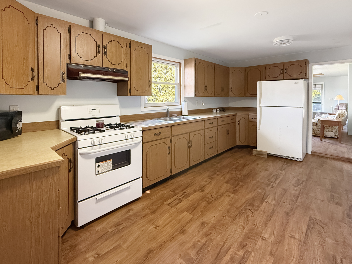 372 North 2629th Road Oglesby, IL 61348 - Photo 16 of 22 a kitchen with wooden cabinets and white appliances
