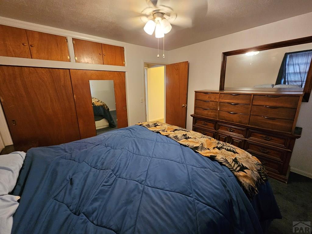 900 Rittgers Street Eads, CO 81036 - Photo 18 of 35 a bedroom with a bed and a flat tv screen on dresser