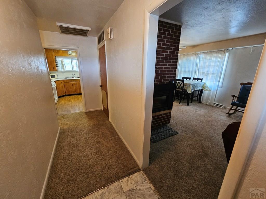 900 Rittgers Street Eads, CO 81036 - Photo 3 of 35 a view of a hallway to a livingroom with furniture and windows