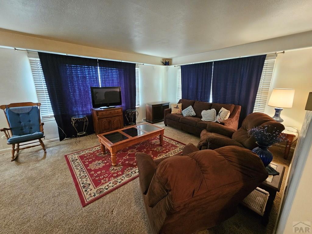 900 Rittgers Street Eads, CO 81036 - Photo 4 of 35 a living room with furniture a flat screen tv and a window