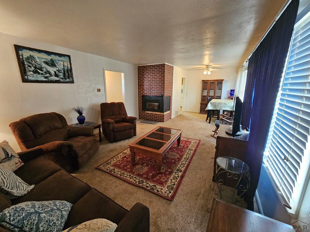 900 Rittgers Street Eads, CO 81036 - Photo 5 of 35 a living room with furniture and a fireplace