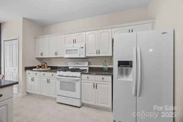 a kitchen with cabinets appliances and a counter space