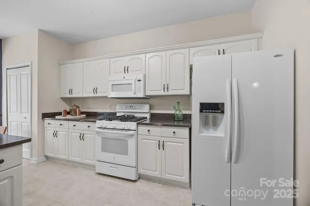 a kitchen with cabinets appliances and a counter space