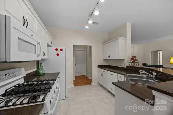 a kitchen with stainless steel appliances granite countertop a stove and a sink