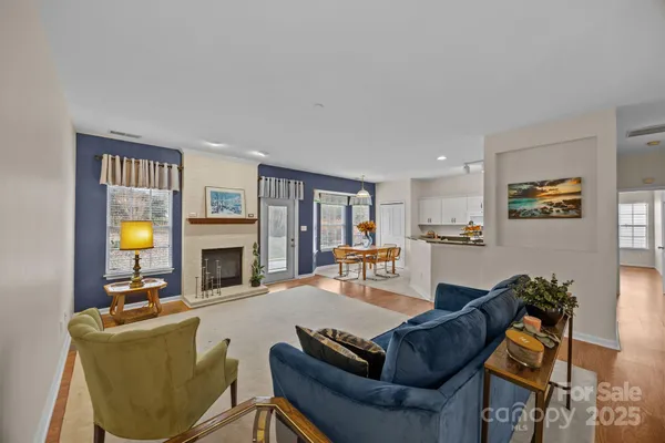 a living room with furniture a fireplace and a window