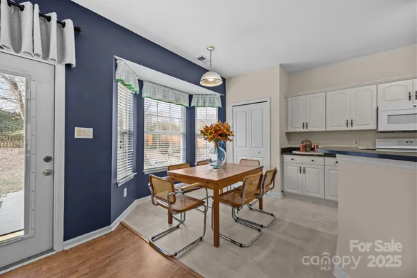 a view of a kitchen with a table and chairs