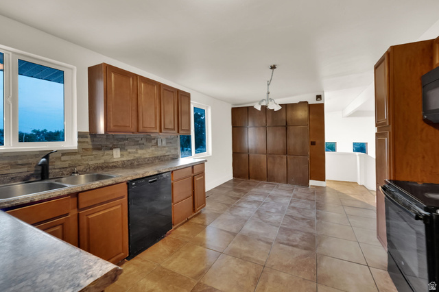 360 400 North Centerville, UT 84014 - Photo 14 of 30 Kitchen featuring wood-finish cabinetry, a double basin stainless steel sink with a matte black faucet, and a stone-tile backsplash