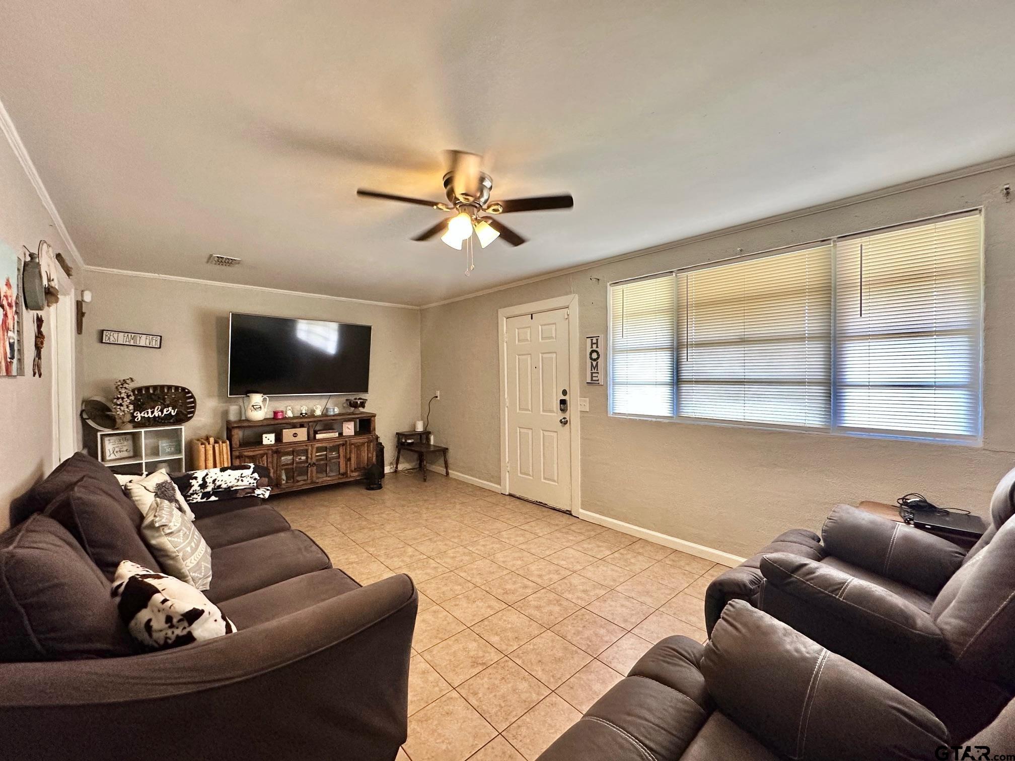 2601 East George Richey Road Longview, TX 75604 - Photo 9 of 26 a living room with furniture and a flat screen tv