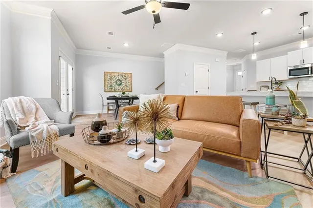 a living room with furniture wooden floor and a chandelier