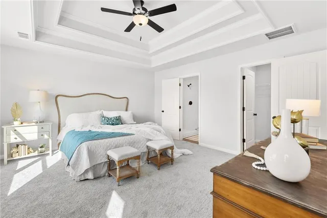 a bedroom with a bed and ceiling fan