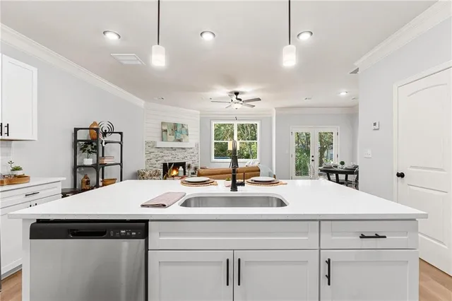 a kitchen with kitchen island a counter space a sink appliances and a window