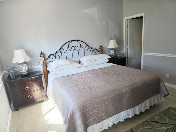 a bedroom with a bed and a mirror