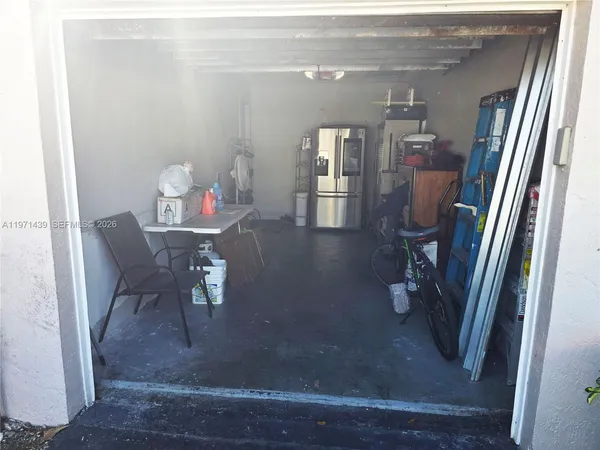 a dining room with furniture and a floor to ceiling window