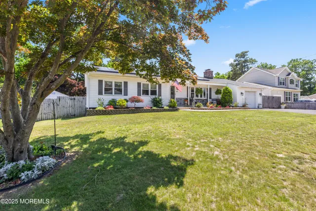 a house view with a sitting space and garden