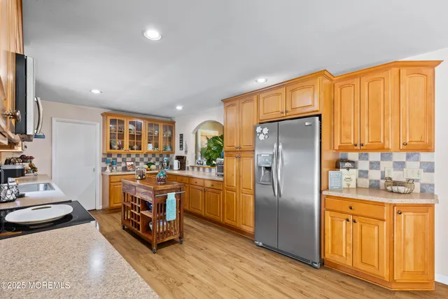 a kitchen with stainless steel appliances granite countertop a refrigerator stove and sink