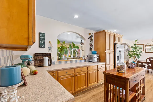 a kitchen with sink refrigerator and cabinets