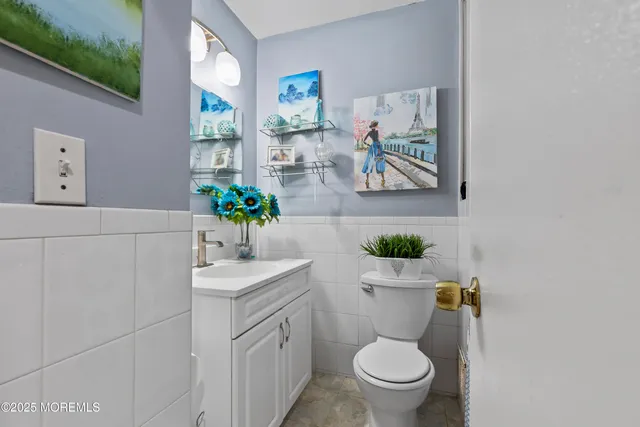 a bathroom with a sink mirror and toilet