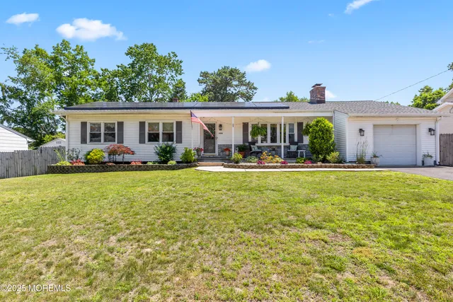 a front view of house with yard and outdoor seating