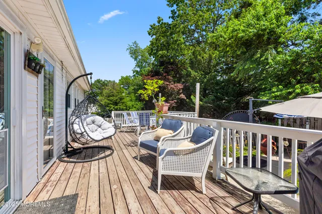 a view of balcony with wooden floor and outdoor seating