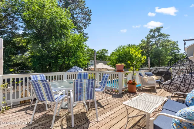 a view of balcony with wooden floor and outdoor seating