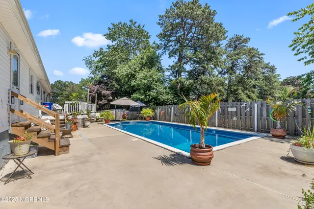 a view of a swimming pool with a bench and tables