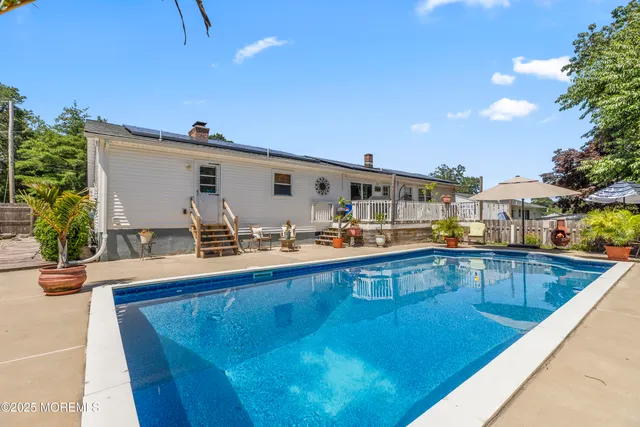 a view of a swimming pool with outdoor seating