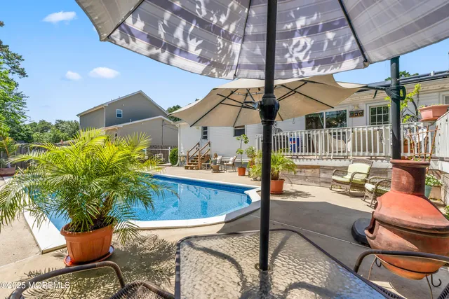 a view of a swimming pool with a patio