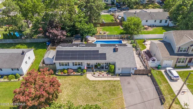 an aerial view of a house with swimming pool and outdoor space