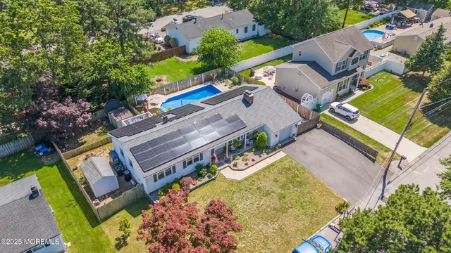 an aerial view of a house with a garden and swimming pool