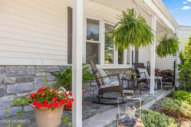 a wooden bench sitting in front of a house