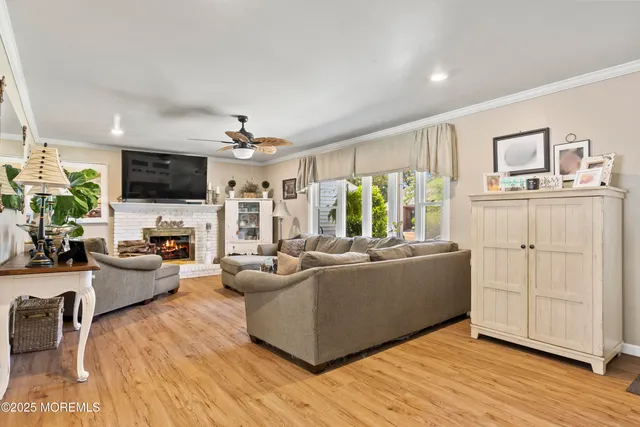 a living room with furniture a flat screen tv and wooden floor