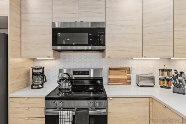 a kitchen with stainless steel appliances a stove and a microwave