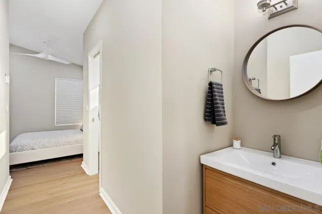 a bathroom with a sink a mirror and a toilet