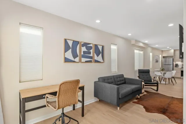 a living room with furniture and a potted plant